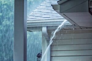 Water running over clogged gutter. Get Gutter Helmet and Neve deal with Clogs again.